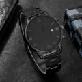 Detailed close-up of a minimalist black men's business watch with a calendar window - Black Watch