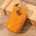 Astuccio per chiavi in pelle vintage con cerniera e gancio metallico in design giallo. - Arancione