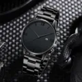 Detailed view of an all-black men's wristwatch with metal strap and Roman numerals. - Simple Black Quartz Watch / Black