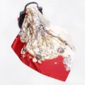 Silk square scarf detail showcasing elegant red and white floral vine print draped gracefully. - D9160 - Red