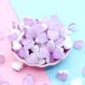 Detailed view of purple and white heart-shaped resin charms for DIY slime and craft projects - 18x10mm / Purple