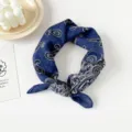 Close-up detail of the classic blue paisley printed cotton square scarf headwrap accessory. - Pink Stripes