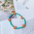 Braccialetto di perline turchesi fatto a mano con margherite arancioni, stile dolce, quotidiano. - Blu lago