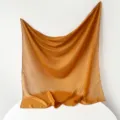 Detail view of the golden brown Turkish yarn square scarf, lightweight and breathable fabric. - Ginger Yellow