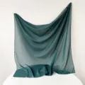 Detailed view of the dark green Turkish gauze square scarf showing delicate fabric texture. - Emerald Green