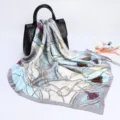 Detail view of a 90cm satin silk square scarf featuring elegant chain and tassel prints. - D9033-Grey Blue