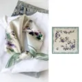 Silk square scarf detail view showcasing elegant floral print and smooth fabric texture. - Bloom in Purple