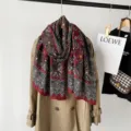 Detail view of the autumn paisley print scarf in rich angola red, soft texture and classic pattern. - Red