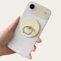 Detailed view of a cream magnetic phone ring holder stand attached to a white smartphone - Magnetic Stand / Yellow
