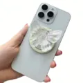 Detailed view of the iridescent laser butterfly phone grip on a white smartphone - Magnetic Stand / Aurora Clear