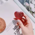Macro detail of a red glitter heart-shaped retractable badge reel for nurse ID holders - Glitter Sequin Heart (No. 9)