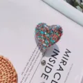 Close-up of heart-shaped retractable badge holder with vibrant colorful glitter sequins - Glitter Sequin Heart (No. 11)