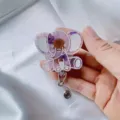 Detailed view of cartoon elephant retractable badge reel with real purple dried flowers - Purple Chrysanthemum Elephant Badge Reel