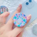 Uitschuifbare telefoonhouder met katten- en bloemenprint op een blauwe smartphone - 1.10