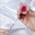 Close-up detail of a floral UV printed retractable badge reel with an extendable cord - Flower Style / Pink Gradient