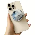 Close-up of a faux moonstone acrylic phone grip stand attached to a gold smartphone. - Magnetic Stand / Gray Blue Milky White Crystal
