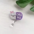 Retractable nurse badge reel with a cute glittery Chill Pill character design - Purple Pill Badge Reel