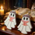 Detailed macro shot of Halloween ghost acrylic earrings featuring pink floral crowns - Reading Ghost (WEH3546)