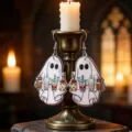 Detail view of Halloween ghost acrylic earrings on a vintage candlelit stand - Beverage Ghost (WEH3547)