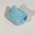 Close-up of a blue star-shaped plush wrist rest with soft texture and elastic band - Solid Color / Blue
