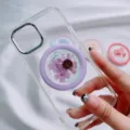 Close-up of a MagSafe phone grip with real purple pressed flowers on a clear case - Magnetic Stand / Purple Chrysanthemum