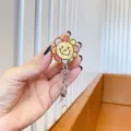 Detailed view of colorful doodle flower retractable badge reel with smiley face drawing. - Graffiti Sun Flower