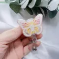 Close-up of butterfly resin badge reel with gold foil and real flower details - White Butterfly Yellow Flower