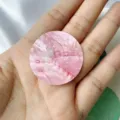 Detailed macro view of a 38mm round pink natural shell slice with iridescent texture - Frosted / Red Round