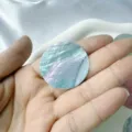 Macro detail of a round iridescent mother-of-pearl shell sticker for DIY jewelry crafts. - Frosted / Blue Round