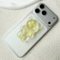 Close-up view of a 3D resin bear phone grip with lemon slice decorations on a phone. - Adhesive / Light Yellow