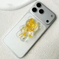 Macro detail view of 3D bear resin phone stand with embedded yellow flower petals for smartphone - Adhesive / Dark Yellow