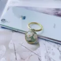 Elegant floral pattern phone ring holder stand with gold metallic finish displayed on an iPhone - Finger Ring Holder / Gold-2