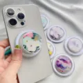Floral pattern magnetic phone grip attached to a silver smartphone with additional designs. - Magnetic Stand / Floral 9