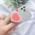 Pink gradient heart-shaped expandable phone socket grip on white phone - Expanding Stand / Pink