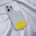 Detail view of a universal yellow phone lanyard gasket patch for clear cell phone cases - Yellow Card