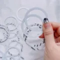 Close-up of white magnetic ring sheets for MagSafe phone charging. - 10 Pieces Pack / Magnetic Ring Pack