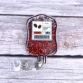 Macro detail of a coffee-themed blood bag retractable badge reel with red glitter shaker - Blood Bag 2 (Coffee Fuel)