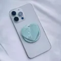 Detailed view of iridescent heart-shaped seashell pattern MagSafe phone grip accessory. - Heart Magnetic Holder / Green Scallop