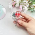 Close-up detail of a heart-shaped retractable badge reel with real dried flowers in resin - Heart Real Flower Badge Reel 4
