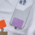 Close-up of a purple universal phone lanyard gasket insert inside a clear phone case. - Purple Card
