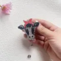 Retractable glittery cow head acrylic badge reel with red bow for nurse and student - Cow