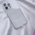 Detailed macro view of a clear universal phone lanyard gasket patch inside a phone case - White Card