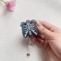 Detail view of glitter acrylic skeleton ribcage retractable badge reel with heart - Ribs with Heart Style