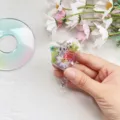 Close-up view of a heart-shaped retractable badge reel featuring embedded colorful real dried flowers - Heart Real Flower Badge Reel 1