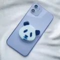 Detail view of a cute panda face acrylic expandable phone grip on a purple phone - Expanding Stand / Panda Head Type 2