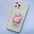 Detailed view of transparent bear phone grip with pink lollipop on white smartphone - Expanding Stand / Light Pink Lollipop Bear