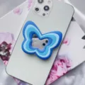 Close-up of blue butterfly-shaped silicone phone grip with built-in mirror - Butterfly Airbag Stand / Blue