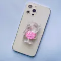 Close-up of a transparent cartoon bear phone grip with a pink and white lollipop design - Expanding Stand / Dark Pink Lollipop Bear