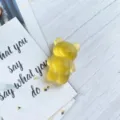 Close-up of a cute yellow gummy bear phone grip with a frosted semi-transparent finish. - Expanding Stand / Light Yellow Frosted Bear