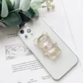 Primo piano del simpatico porta cellulare a forma di orsetto glitter oro - Supporto Orso / polvere scintillante dorata